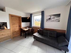 a living room with a couch and a table at Studio Rehkitz by Interhome in Kaprun