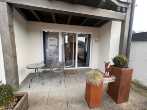 a patio with a table and chairs and a table at Studio Rehkitz by Interhome in Kaprun