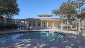 a swimming pool in front of a house at Oak Glen 84 in Ocean Springs