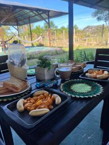 a table topped with trays of food and bread at Glamping Amazonas in Leticia