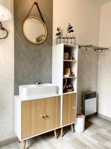 a bathroom with a sink and a mirror at Nordic Nest in Givet