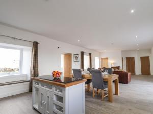 a kitchen and living room with a table and chairs at Firthview in Nairn