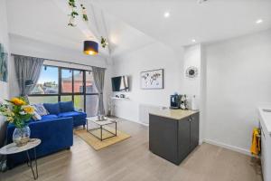 a living room with a blue couch and a table at The Central Winchester Gem - Sleeps 2 in Winchester