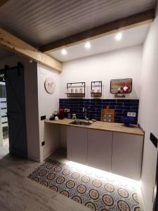 a kitchen with a sink and a counter top at Studio with furnished terrace at Riogordo in Ríogordo