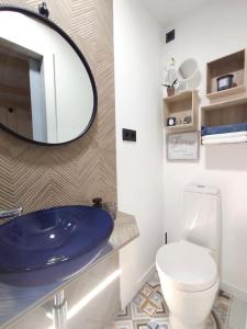 a bathroom with a blue sink and a toilet at Studio with furnished terrace at Riogordo in Ríogordo