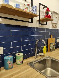 a kitchen counter with a sink and blue tiles at Studio with furnished terrace at Riogordo in Ríogordo