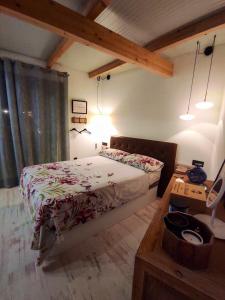 a bedroom with a bed and a table in a room at Studio with furnished terrace at Riogordo in Ríogordo
