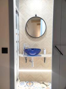 a bathroom with a blue sink and a mirror at Studio with furnished terrace at Riogordo in Ríogordo