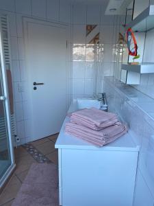 a white bathroom with a counter with towels on it at Studio - a79311 in Loxstedt
