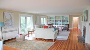 a living room with a white couch and a table at 160 Long Pond Drive Harwich Cape Cod - Old Camp in Harwich