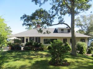 a house with a tree in the yard at 160 Long Pond Drive Harwich Cape Cod - Old Camp in Harwich