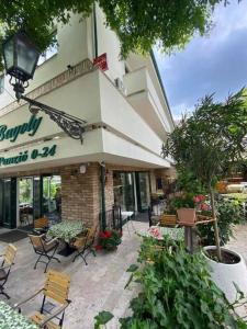 a restaurant with chairs and tables in front of a building at Free public parking BumbleBee Apartment 4ppl AC FastNet TV in Budapest