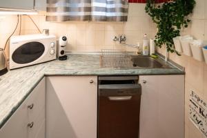 a kitchen with a sink and a microwave at Free public parking BumbleBee Apartment 4ppl AC FastNet TV in Budapest