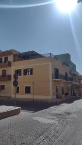 a large building on a street in front of a building at LechicchediLampedusa in Lampedusa