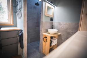a bathroom with a sink and a shower at Tauernlust Outdoor & Relax in Mallnitz