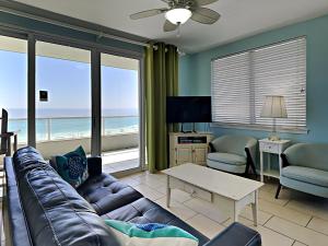 a living room with a couch and views of the ocean at Silver Beach 506 orange Beach in Orange Beach