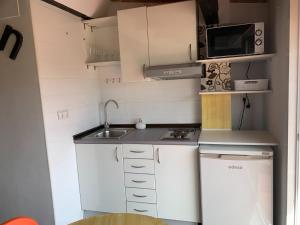 a small kitchen with a sink and a microwave at Valencia Central Loft in Valencia