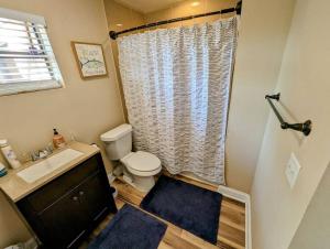 a bathroom with a toilet and a sink and a shower at Modern & Comfy Lagoon Oasis - River Views - Parking in Titusville