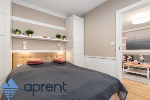 a bedroom with a large bed in a room at Apartament AURI Pobierowo Baltic Apartments - Aprent in Pobierowo