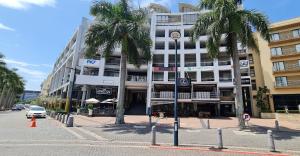 un edificio en una calle con palmeras delante en 12 Palm Boulevard en Durban