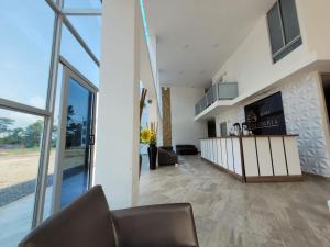 a living room with a couch and a large window at HOTEL COLOMBIA BYB in San Alberto