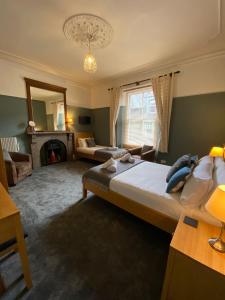 a bedroom with a large bed and a fireplace at Ambleside Central in Ambleside