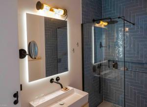 a bathroom with a shower and a sink and a mirror at MrSTiL Design Aparthotel in Berlin