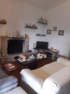 a living room with a couch and a fireplace at la casa di Mario in Itri