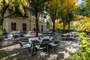a group of tables and chairs in front of a building at Hostel Vrba in Ljubljana