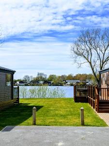 a view of a lake with a building and a house at Tattershall Lakes - Merlin Point in Tattershall