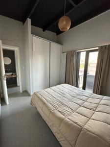 Postel nebo postele na pokoji v ubytování Departamento Privado En La Ruta Del Vino