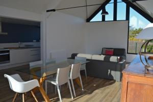 a kitchen and dining room with a glass table and chairs at Villa 1 in Saint-Jacut-de-la-Mer