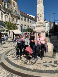 um grupo de pessoas em pé em frente a uma estátua em Aveiro Central Its ALL there Apartment em Aveiro