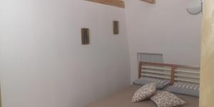 a room with a bench and two pillows on the floor at Cummersa dell'alba in Locorotondo
