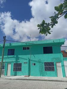 a green building on the side of a street at Sandy's room in Cancún