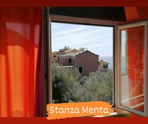 a window with a view of a city at Perla del Levante Hostel in Framura