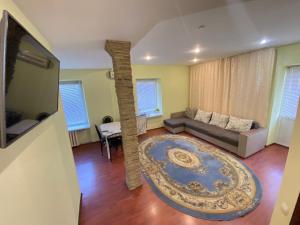 a living room with a couch and a table at Stefan cel Mare Boulevard Ultracentral Apartments in the Center Chisinau in Chişinău
