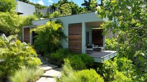 a guest house with a garden and a patio at Villa Kaya in Morne Rouge