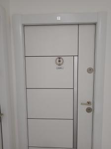 a white cabinet with a glass door in a room at Nikolici - Free Parking in Vranje