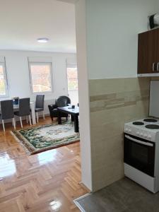 a kitchen and dining room with a table and a stove at Nikolici - Free Parking in Vranje
