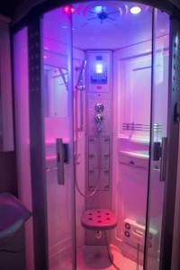 a bathroom with a shower and a stool in it at Villa Tuman Loutra Pozar Aridaias in Aridaia