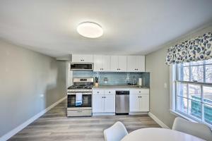 a kitchen with white cabinets and a stove at Lovely Rockport Apartment, Walk to Beaches! in Rockport