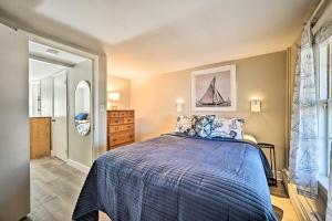 a bedroom with a bed with a blue comforter at Lovely Rockport Apartment, Walk to Beaches! in Rockport