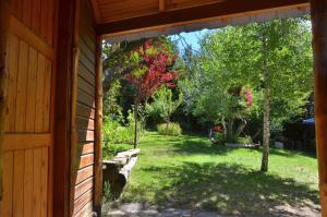 a view of a yard from the side of a house at ABEDULES CABAÑAS PEHUENIA in Villa Pehuenia +14 photos