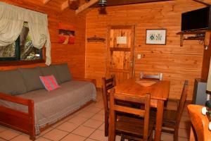 a living room with a couch and a table at ABEDULES CABAÑAS PEHUENIA in Villa Pehuenia
