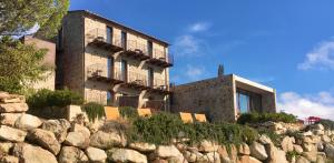 a building on top of a rock wall at VALDONICA Winery I Residence I Restaurant in Sassofortino