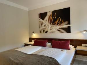 a bedroom with two beds and a painting on the wall at Landhaus Oberaurach in Oberaurach