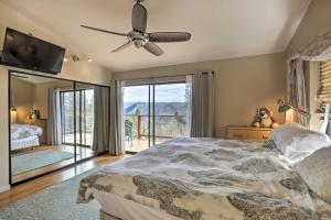 a bedroom with a bed and a ceiling fan at Homey Colfax Getaway with Private Hot Tub! in Colfax