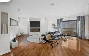 a living room with a table and chairs in it at Panorama Hudson River view in Edgewater