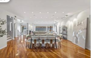 a dining room with a table and chairs at Panorama Hudson River view in Edgewater